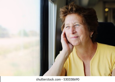 Portrait Of Beautiful 70 Years Old Woman Sitting In The Train