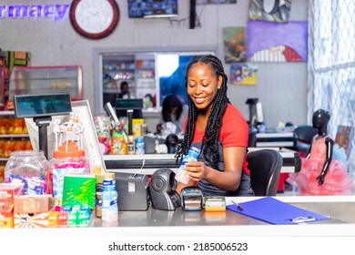 Portrait Of Beautiful African American Smiling Cashier Lady Working At A Grocery Store.