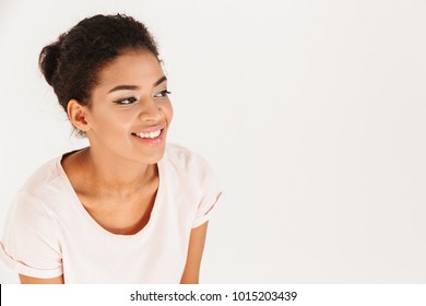 Portrait Of Beautiful African American Woman Smiling And Looking Aside On Copyspace Isolated Over White Background