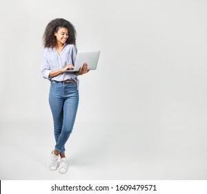 Portrait of a beautiful african woman with laptop on grey background