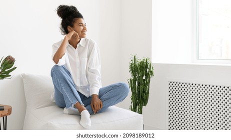 Portrait Of Beautiful Afro American Woman Looking Out The Window. Professional Photo Session In Studio. Beautiful Girl Posing At Home. Femininity Concept