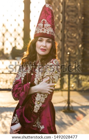 
Portrait of a beautiful arab girl in traditional dress against the background of the sights in Kazan