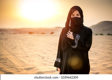 Portrait of beautiful Arab woman in the desert during sunset. - Shutterstock ID 1039642309