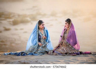 portrait of  beautiful Arabian girls in traditional suit with valuable accessory, Persian girls in desert