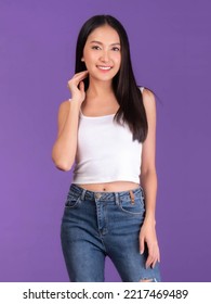 portrait of Beautiful Asian brunette woman cute girl in white tank top , girl standing smile and happiness isolated on purple background