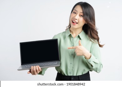 Portrait Of A Beautiful Asian Businesswoman Pointing Her Finger At The Laptop Screen
