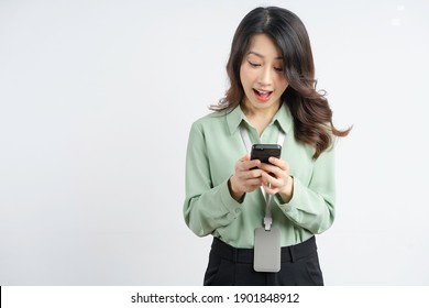 Portrait of a beautiful Asian businesswoman using a smartphone with a surprised face
