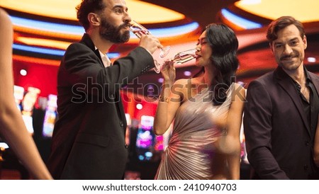 Portrait of a Beautiful Asian Female Winning a Bet at a Casino Table. Young Glamorous Woman is Excited, Can't Believe Her Luck. Looking at Her Stylish Boyfriend and Celebrating