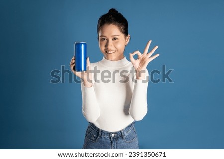 Portrait of beautiful asian girl posing on blue background