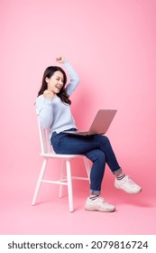 Portrait Of Beautiful Asian Girl Sitting In Chair, Isolated On Pink Background