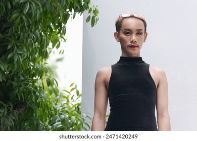 Portrait of beautiful Asian queer LGBT community supporter man with mustache wearing lipstick and jumpsuit - Powered by Shutterstock