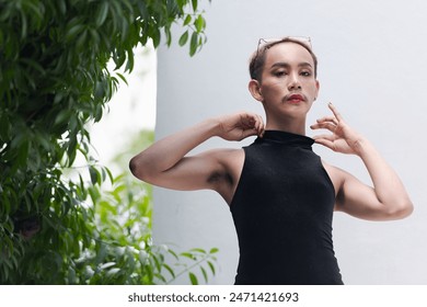 Portrait of beautiful Asian queer LGBT community supporter man with mustache wearing lipstick and jumpsuit - Powered by Shutterstock