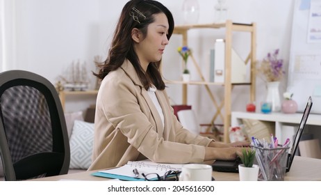 Portrait Of Beautiful Asian Secretary Working On Computer With Concentration In The Office. Genuine Lifestyle