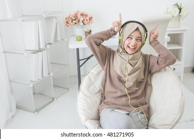 Portrait Of Beautiful Asian Woman Being Silly While Enjoying Music