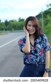 Portrait Of A Beautiful Asian Woman In A Blue Hawaiian Shirt Standing In A Street Pose. . Summer Concept.