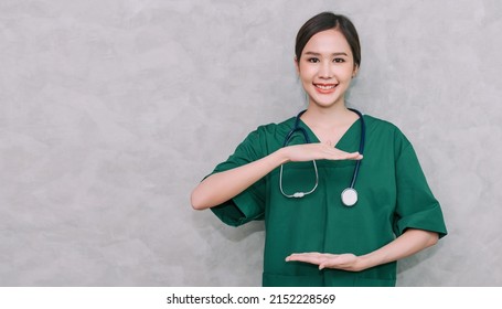 Portrait Of Beautiful Asian Woman Doctor Healthcare Worker Standing And Hand Posing For Present Something Use For Mockup Isolated On Grey Background