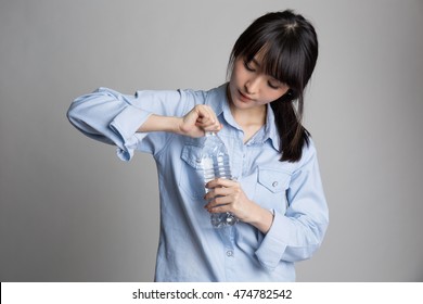 Portrait Of Beautiful Asian Woman Holding Water Bottle And Try To Open It.