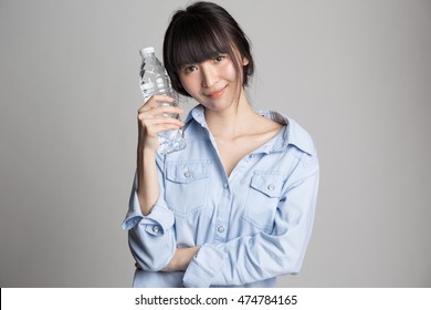 Portrait Of Beautiful Asian Woman Holding Water Bottle.