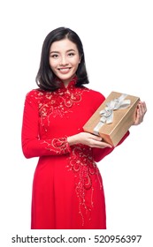 Portrait of a beautiful Asian woman on traditional festival costume Ao Dai holding Gift Box. Tet holiday. Lunar New Year.