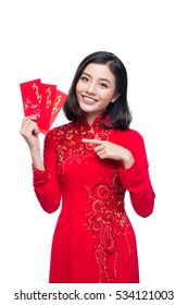 Portrait of a beautiful Asian woman on traditional festival costume Ao Dai holding red pocket - lucky money. Tet holiday. Lunar New Year. Text mean Happy New Year.