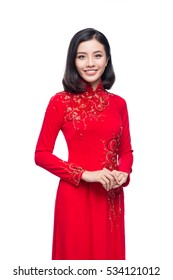 Portrait of a beautiful Asian woman on traditional festival costume Ao Dai holding red pocket - lucky money. Tet holiday. Lunar New Year.