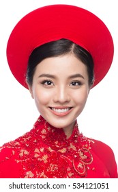 Portrait of a beautiful Asian woman on traditional festival costume Ao Dai holding red pocket - lucky money. Tet holiday. Lunar New Year.
