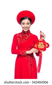 Portrait of a beautiful Asian woman on traditional festival costume Ao Dai. Tet holiday. Lunar New Year.