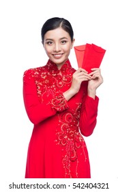 Portrait of a beautiful Asian woman on traditional festival costume Ao Dai holding red pocket - lucky money. Tet holiday. Lunar New Year.