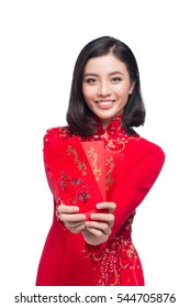 Portrait of a beautiful Asian woman on traditional festival costume Ao Dai holding red pocket - lucky money. Tet holiday. Lunar New Year.