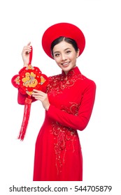 Portrait of a beautiful Asian woman on traditional festival costume Ao Dai. Tet holiday. Lunar New Year.