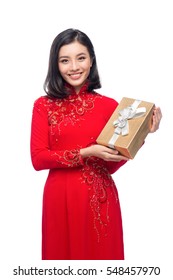 Portrait of a beautiful Asian woman on traditional festival costume Ao Dai holding Gift Box. Tet holiday. Lunar New Year.