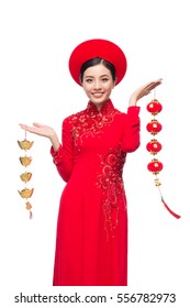 Portrait of a beautiful Asian woman on traditional festival costume Ao Dai. Tet holiday. Lunar New Year.