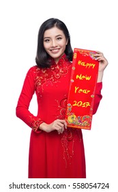 Portrait of a beautiful Asian woman on traditional festival costume Ao Dai holding red pocket - lucky money. Tet holiday. Lunar New Year.