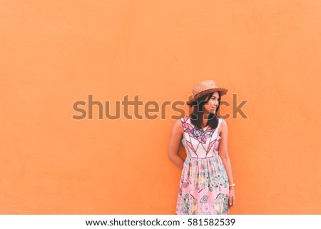 Portrait of beautiful asian woman pose on orange wall,lifestyle of single girl