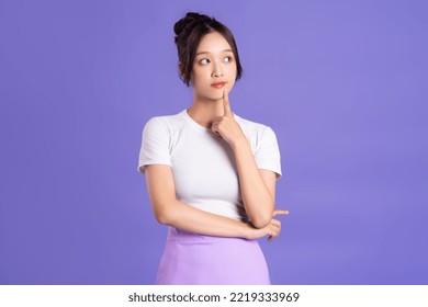 Portrait of a beautiful Asian woman posing on a purple background - Shutterstock ID 2219333969