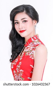 Portrait of beautiful asian woman in red chinese dress traditional cheongsam. chinese new year concept. Cheerful girl in red cheongsam on white background.