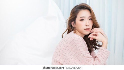 Portrait Of Beautiful Asian Woman Relax Face In Winter Bedroom. Sexy Beauty Girl With Healthy Makeup Facial Treatment Perfect Glow Skin. Smile Happy Hygge Asian Korean Girl Isolated White Background.