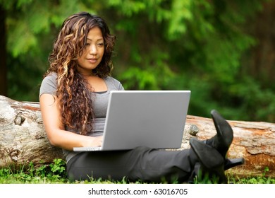 Portrait Of Beautiful Asian Woman Using Laptop Outdoor