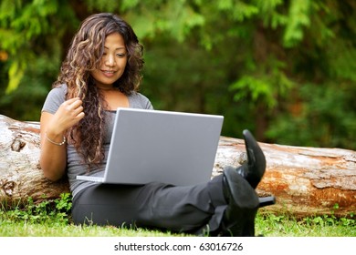 Portrait Of Beautiful Asian Woman Using Laptop Outdoor