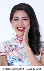 Portrait of beautiful asian woman in white chinese dress traditional cheongsam. chinese new year concept.Smiling Chinese woman is holding red packet of Ang Pao and gold present of Chinese New Year. 
