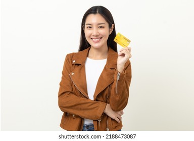 Portrait Beautiful Asian Women In Jacket Fashion Jean Standing Pose Holding Credit Card To Shopping Payment. Attractive Happy Businesswoman With Creditcard.