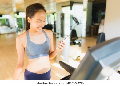 Portrait Beautiful Asian Young Woman Using Mobile Phone In Gym Room