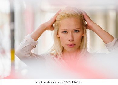 Portrait of a beautiful, attractive, sexy platinum blond Caucasian woman standing in front of no access tape. She looks serious and it has the concept of censorship and free speech silenced.