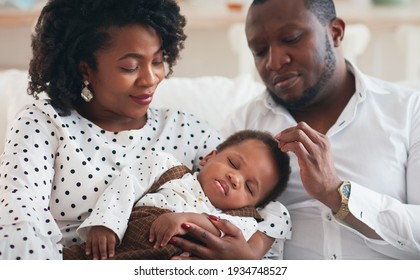 Portrait Of Beautiful Baby Boy Sleeping Peacefully In Parents Hands