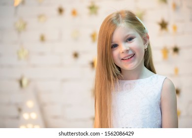 Portrait Of A Beautiful Baby Girl. The Face Of A Five Year Old Child. Small Model