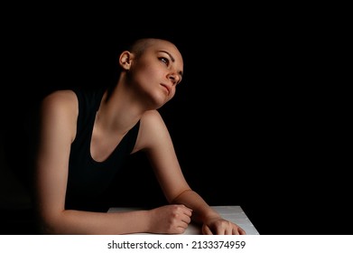 Portrait Of A Beautiful Bald Woman. Studio Shot On Dark Background