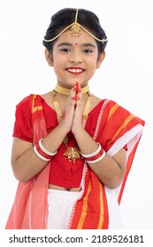 Portrait Of Beautiful Bengali Girl Greeting In Traditional Red And White Sari With Jewelry
