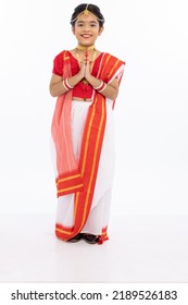 Portrait Of Beautiful Bengali Girl Greeting In Traditional Red And White Sari With Jewelry
