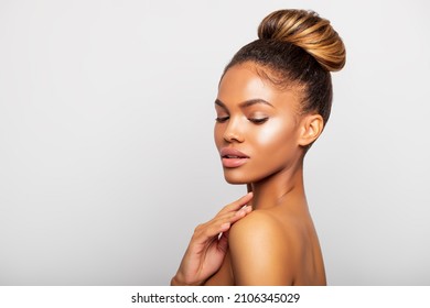 Portrait Of A Beautiful Black Woman With Perfect Healthy Skin, Light Make-up, Hair In A Bun. Beauty. Gray Background. Close-up Fashion Portrait African American Girl In Profile. 