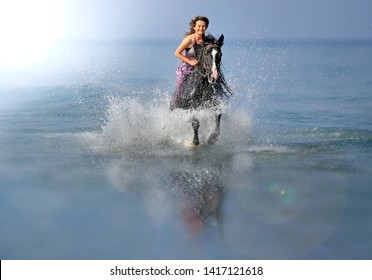 Portrait of a beautiful blond girl  galloping on horseback, dissecting waves on the sea beach